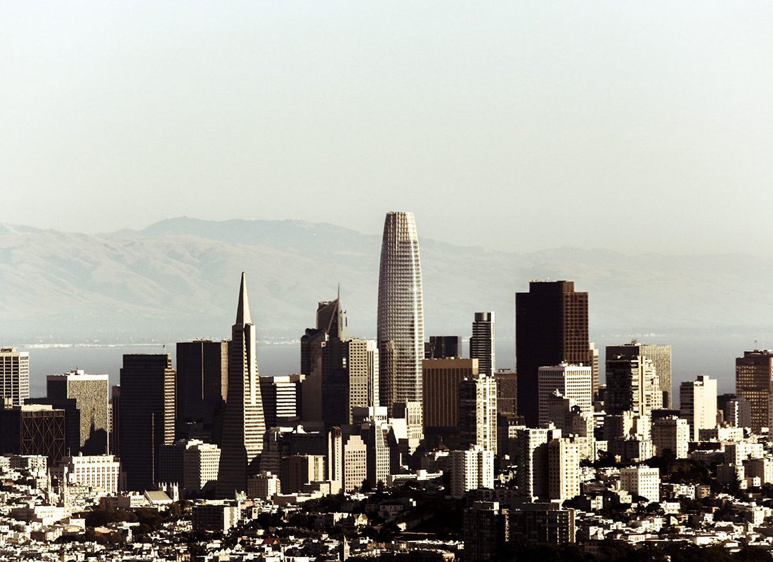 About Our Agency - Aerial View of the Cityscape of San Francisco With Many Tall Buildings With Sharp Shadows During a Very Bright Day